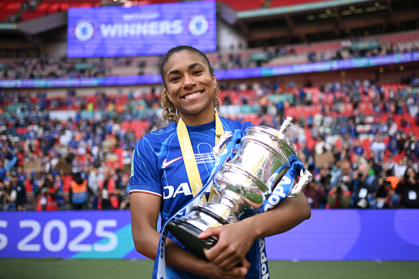 Catarina Macario poses with the FA Cup after scoring in our final victory over Manchester United